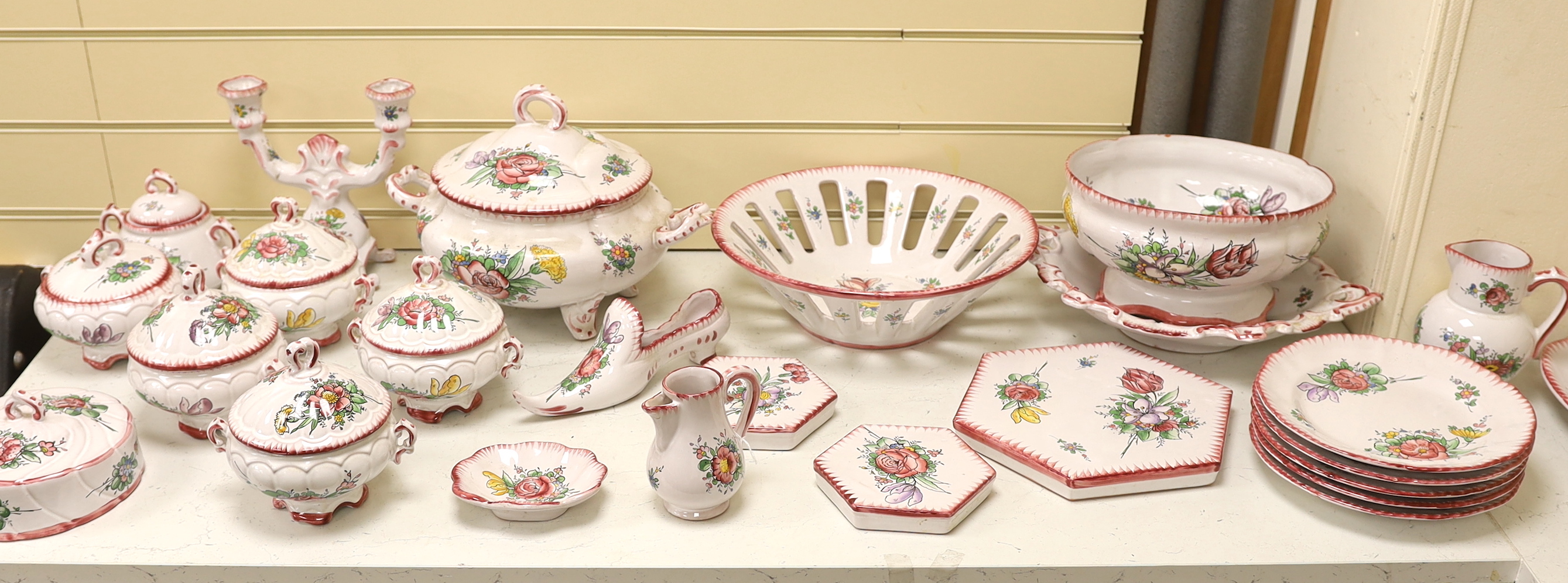 Le Renoleau Faiencerie D'Art, Angouleme, French faience tableware with floral decoration, including lidded serving pots, tureens, jugs, serving dishes, coasters, plates, candle stands, a candlestick, a water dispenser fo
